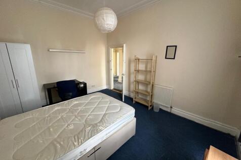 A spacious double bedroom with good natural lig...