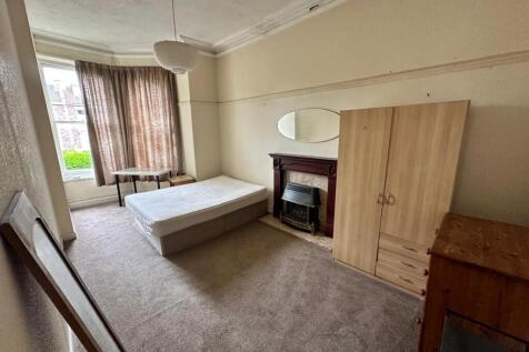 A spacious and inviting double bedroom with lar...