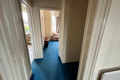A well-maintained hallway leading to various ro...