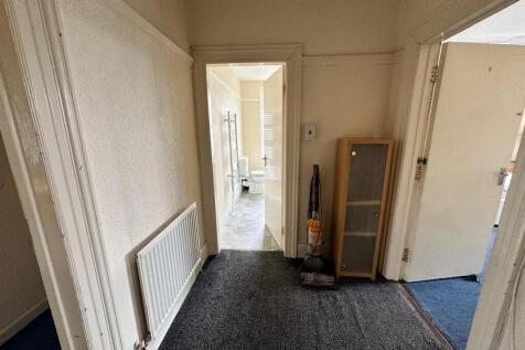 A clean and spacious hallway leading to various...