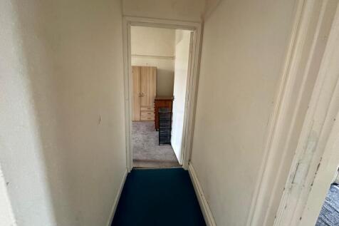 A simple and clean hallway leading to other roo...