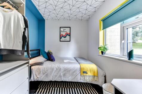 A cozy double bedroom featuring a vibrant color...