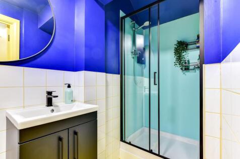 This stylish bathroom features a modern shower ...