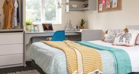 This inviting double bedroom features a cozy at...