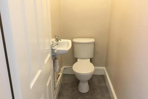 This compact single toilet features a clean and...