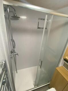 Modern bathroom shower with sliding glass door ...