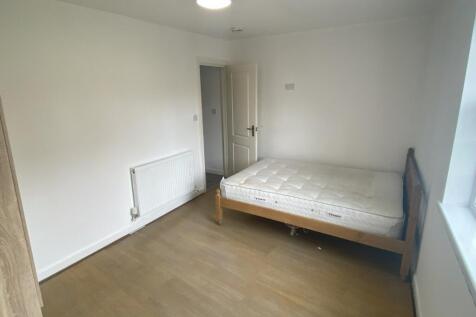 A bright and simple single bedroom featuring a ...
