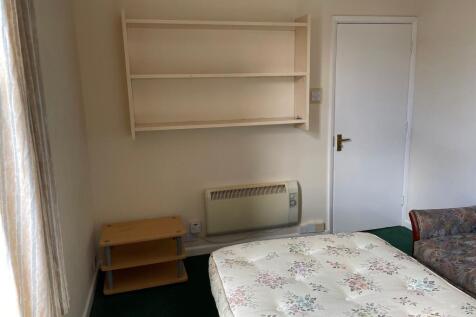 This cozy double bedroom features a comfortable...