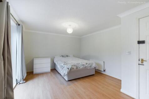 Spacious double bedroom featuring a comfortable...