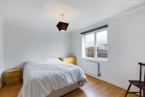 Spacious double bedroom featuring large windows...