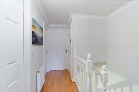 A bright and inviting hallway featuring clean l...