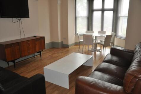 A spacious and well-lit modern living room, per...