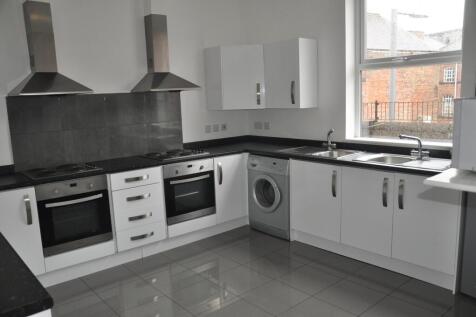 A modern and spacious kitchen with ample storag...