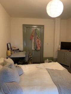 A cozy double bedroom with a comfortable bed an...