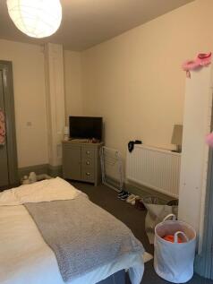 A cozy double bedroom with ample space and a we...