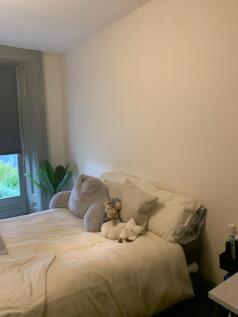 A cozy double bedroom featuring soft bedding an...