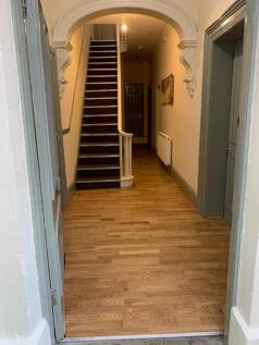 A spacious and tidy hallway with stylish archit...