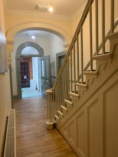 A well-maintained hallway with a welcoming entr...