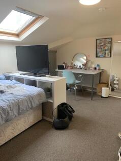 Bright and cozy master bedroom featuring a comf...