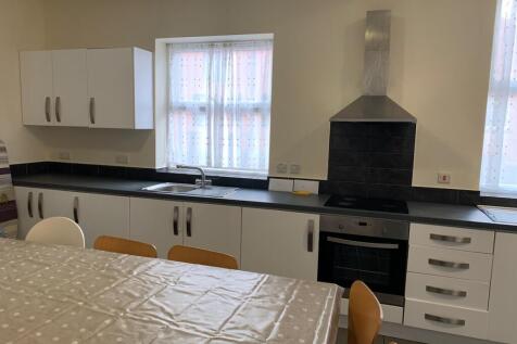 Bright and modern kitchen featuring clean white...