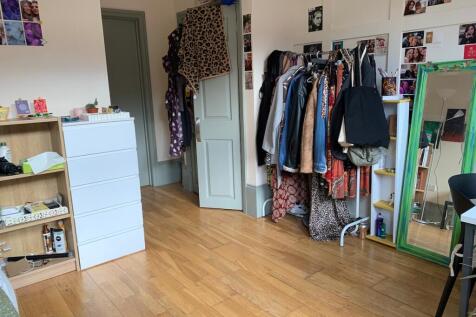 Bright and cozy double bedroom featuring polish...