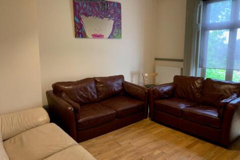 A cozy living room featuring two brown leather ...