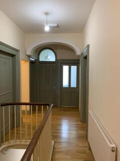 Bright and clean hallway with polished wooden f...