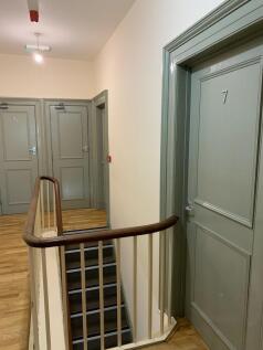A clean and well-maintained hallway with light ...
