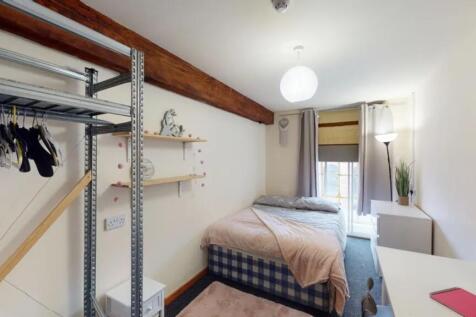 A charming and tidy double bedroom featuring am...