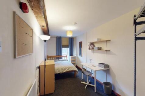 A spacious and well-lit double bedroom featurin...