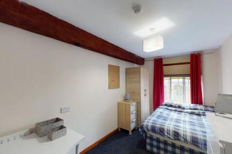 A bright and inviting double bedroom with moder...
