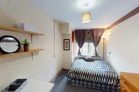 A bright and inviting double bedroom with moder...