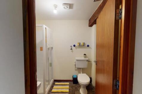 A clean and functional bathroom featuring a sho...