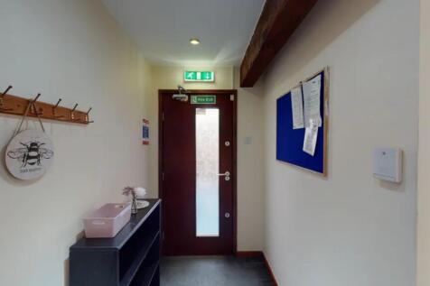A tidy and inviting hallway with ample natural ...
