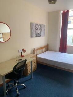 A bright and inviting double bedroom with ample...