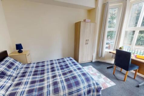 A bright and inviting double bedroom with ample...