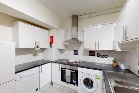 A bright and modern kitchen with ample storage ...