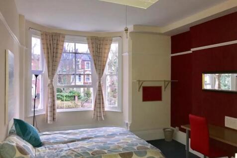 A bright and inviting double bedroom with large...
