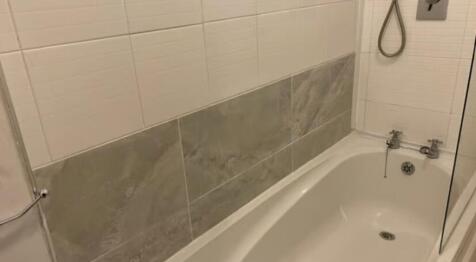 A clean and modern bathroom featuring a white b...
