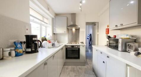 Bright and modern kitchen featuring ample count...