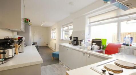 Bright and airy kitchen featuring ample counter...