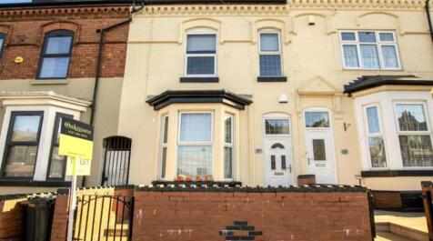 A charming terraced house exterior featuring a ...
