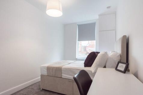 A modern and tidy double bedroom featuring a co...
