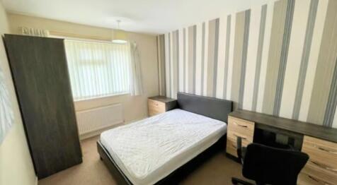 A neat and well-lit double bedroom featuring a ...