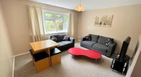 A cozy living room featuring two comfortable gr...