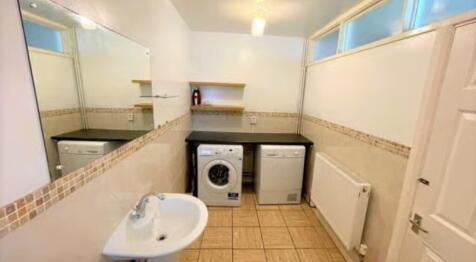 A neat and functional laundry room featuring a ...