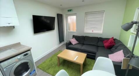 Bright and modern living room featuring a comfo...