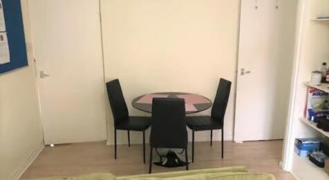A compact living area featuring a small round d...