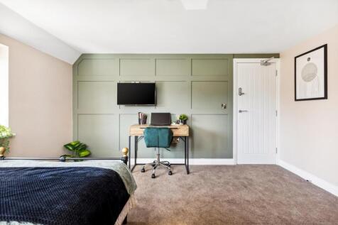 Stylish double bedroom featuring a cozy ambianc...