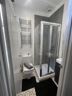 Modern bathroom featuring a sleek glass shower ...